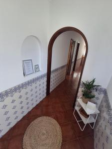 a hallway with a mirror and a tile floor at Casa R in Sesimbra