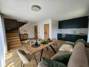 a living room with a couch and a table at Apartamenty Klikuszówka in Nowy Targ