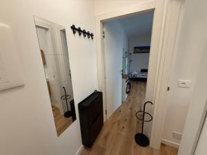 a hallway with a door to a room with a mirror at 11 Apartaclean Cancellieri in Trieste