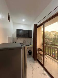 a kitchen with a dishwasher next to a balcony at Watermelon apartment in San Isidro