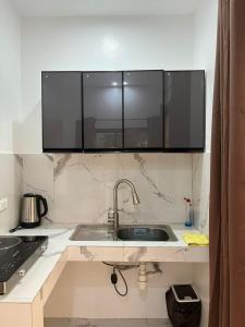 a kitchen with a sink with a microwave above it at Watermelon apartment in San Isidro +5 photos