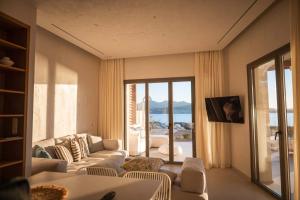 a living room with a couch and a view of the ocean at Dawn Milos in Pollonia