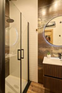 a bathroom with a glass shower and a sink at Los Balcones de San Juan in Salamanca