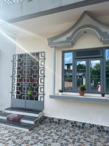 a house with two windows and a tiled floor at inoru house in Khairāni