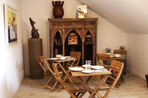 a dining room with tables and chairs and a fireplace at Domaine la Héroïca in Maisonnais