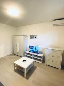 a living room with a coffee table and a tv at Salis in Novigrad Istria