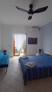 a bedroom with a blue bed and a ceiling fan at Il Casalino in Maratea +209 photos