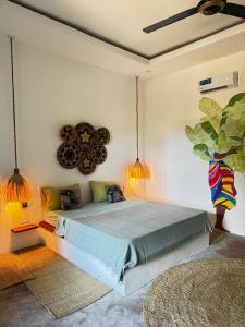 a bedroom with a large bed in a room at FURAHA GARDEN Rooms in Kendwa