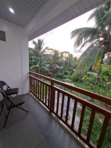 a balcony with a chair and a view of the ocean at Watermelon apartment in San Isidro
