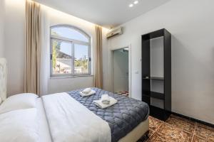 a bedroom with a large bed and a window at Shiroka Stays in Shirokë
