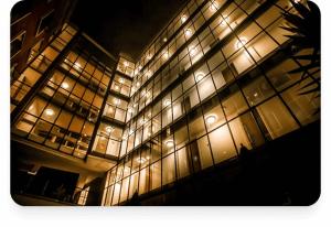 a large building with many windows at night at YMCA Hotel in London +7 photos