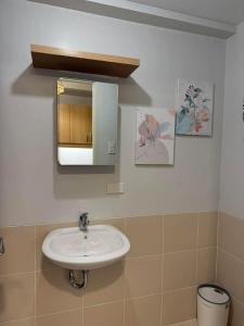 a bathroom with a sink and a mirror at Verdon Parc condominium in Davao City
