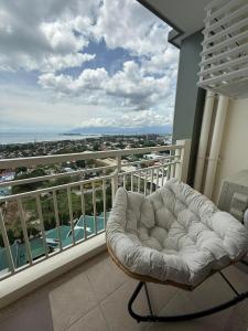 a white couch sitting on a balcony with a view at Verdon Parc condominium in Davao City