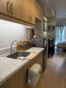 a kitchen with a sink and a counter top at Verdon Parc condominium in Davao City +4 photos
