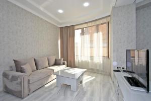 a living room with a couch and a table at Elite & Grand Luxury Hotel Apartments in Central Yerevan, By Opera and Northern Avenue in Yerevan