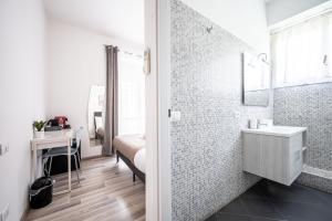 a white bathroom with a sink and a mirror at Da Vinci Suite Modern Rooms near Metro Basilica San Paolo in Rome +29 photos