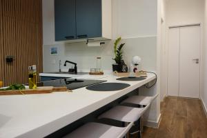 a kitchen with black and white counters and a sink at Zen Loft Quiet Retreat near St julians in Is-Swieqi