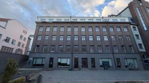a large brick building with a lot of windows at tARTu Stays 5-3 Spacious Apartment Tartu Old Town in Tartu