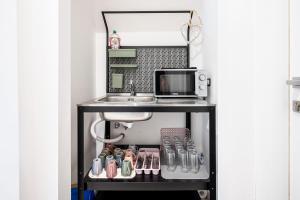 a bathroom vanity with a sink next to a sink at Da Vinci Suite Modern Rooms near Metro Basilica San Paolo in Rome