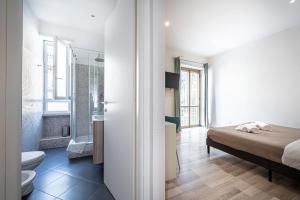 a bedroom with a bed and a bathroom at Da Vinci Suite Modern Rooms near Metro Basilica San Paolo in Rome