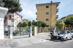 a motorcycle parked in a parking lot next to a building at Da Vinci Suite Modern Rooms near Metro Basilica San Paolo in Rome