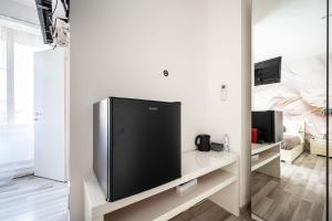 a living room with a large flat screen tv at Da Vinci Suite Modern Rooms near Metro Basilica San Paolo in Rome