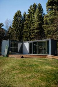 a modern house with glass doors on a yard at Üleoja Pesa in Kloogaranna