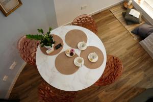 an overhead view of a white table with plates and cups at Zen Loft Quiet Retreat near St julians in Is-Swieqi