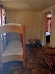 a bunk bed in a room with a bedroom at Cabana Coral Reef in Mandapam