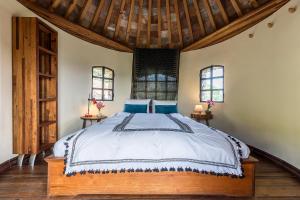 a bedroom with a bed and two windows at Holiday House La Teja in Facinas