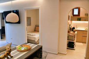 a living room with a table and a room with a bedroom at Villa LEO AIGINA in Vathí