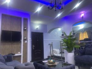 a living room with purple lighting and a couch at Muniz Apartments in Lagos