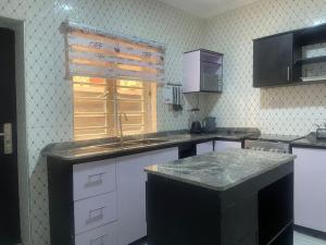 a kitchen with a sink and a window at Muniz Apartments in Lagos