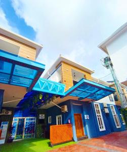 a house with a blue and yellow at Fairtex Luxury Hotel in Lekki