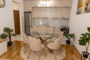 a dining room with a glass table and chairs at Apartment LANA in Čapljina