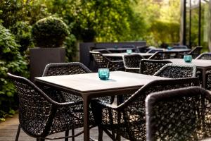 a group of tables and chairs on a patio at Motel One Hamburg-Alster in Hamburg