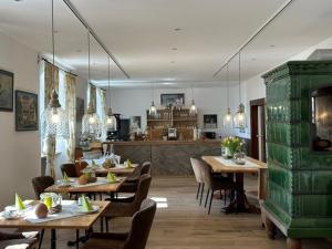 a restaurant with wooden tables and chairs and a kitchen at Hotel Landhaus Sternen in Sipplingen