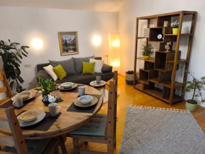 a living room with a table and a couch at Ferienwohnung Gabriel in Bad Kohlgrub