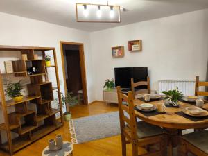 a living room with a wooden table and a television at Ferienwohnung Gabriel in Bad Kohlgrub