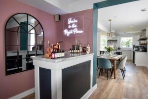 a kitchen and dining room with a bar and a dining table at The Smith - Renovated 4 Bedroom in Bloomfield
