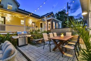 a backyard with a wooden table and chairs and a grill at The Smith - Renovated 4 Bedroom in Bloomfield +49 photos