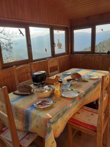 a table in a room with a table cloth on it at Chambres IM-BERG in Metzeral