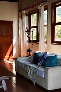 a living room with a couch in a room with windows at Santa Clara Hotel in Paraty +40 photos