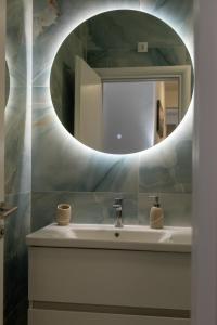 a bathroom with a sink and a mirror at Apartment LANA in Čapljina +8 photos