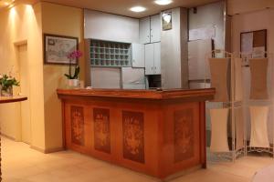 a kitchen with white cabinets and a counter top at Platanes Hotel Apartments Rethymno in Platanes +24 photos