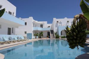 a swimming pool with a bunch of bananas next to a building at Platanes Hotel Apartments Rethymno in Platanes