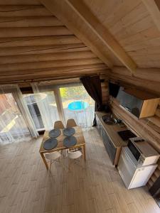 a kitchen with a table and chairs in a room at Verdant House in Mykulychyn