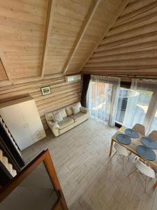 a living room with a couch and a table at Verdant House in Mykulychyn