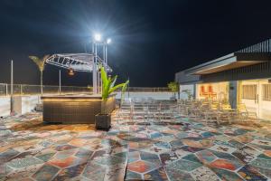 a patio at night with a table and chairs at The Grand Dularia in Nagpur