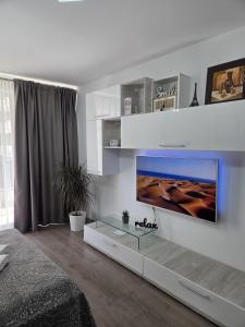 a living room with a flat screen tv on a wall at Wonderful Apartment in Braşov